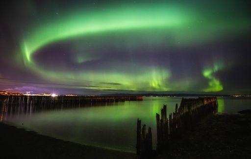 A beautiful view of the aurora borealis reflection on the lake in Lofoten, Norway