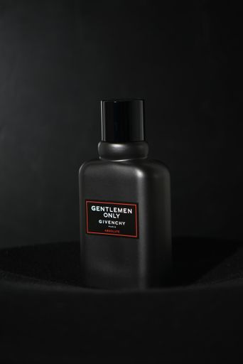 A beautiful vertical shot of "Gentlemen only" men fragrance by Givenchy with a black background