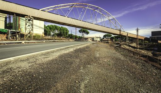 A road with a bridge over it near the Riotinto Mines under the sunlight at daytime in Huelva in Spain