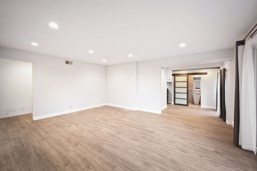 Modern luxury home featuring oversized windows, designer decor, spacious bedrooms, and sweeping views of the surrounding hills.