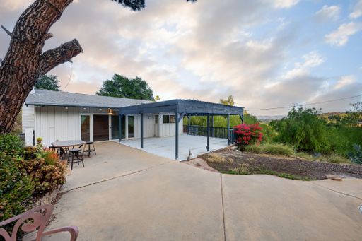 Modern luxury home featuring oversized windows, designer decor, spacious bedrooms, and sweeping views of the surrounding hills.