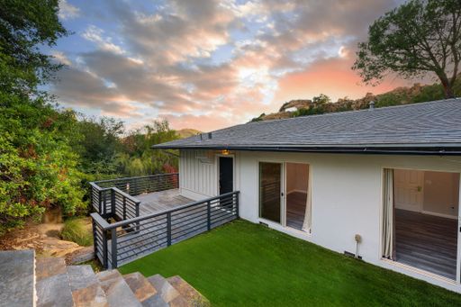 Modern luxury home featuring oversized windows, designer decor, spacious bedrooms, and sweeping views of the surrounding hills.
