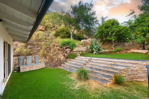 Modern luxury home featuring oversized windows, designer decor, spacious bedrooms, and sweeping views of the surrounding hills.