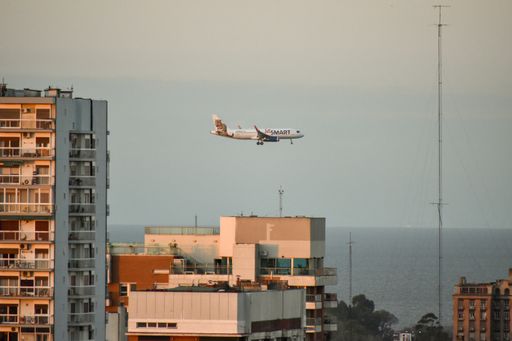 A beautiful view of a Jet Smart airline plane flying over Rio de la Plata drive approaching Aeroparque Newbery airport of Buenos Aires