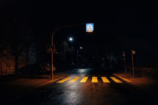 A closeup shot of a pedestrian under the street lights during the night