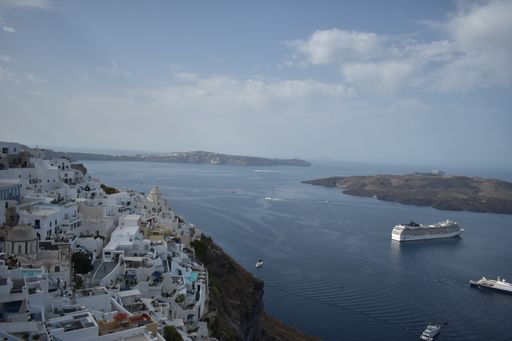 A beautiful view of the white buildings on the cliffs on the coast in Greece