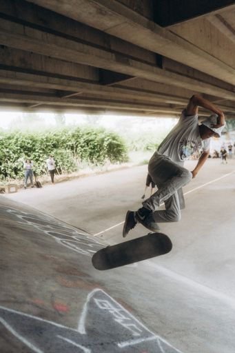 A teenager is skateboarding in skatepark under the bridge in Sarajevo, Bosnia and Herzegovina