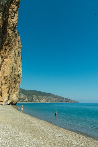 A beautiful scenery of blue water and rocky mountains under a sunny sky in Spiaggia della Marinella in Centola, Italy