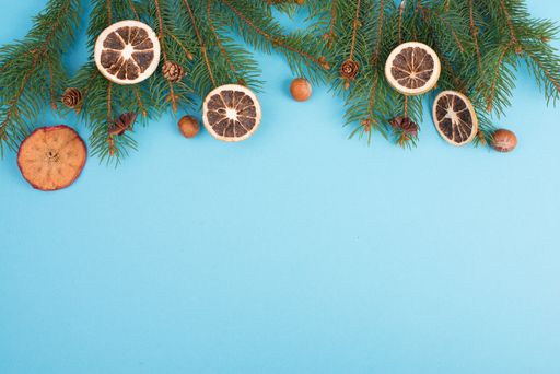 Christmas background with branches of fir, empty copy space, blue backdrop