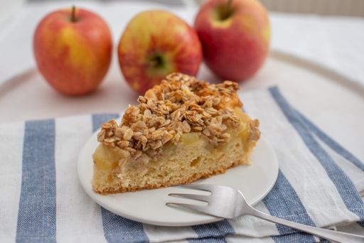 A closeup of a slice of apple cinnamon pie with oatmeal on a plate on the table