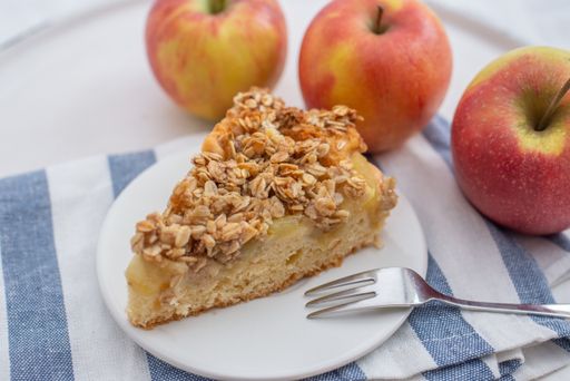 A closeup of a slice of apple cinnamon pie with oatmeal on a plate on the table