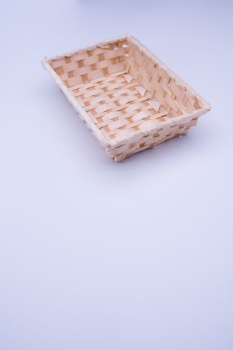 empty rectangular wicker canister on a white background with text space