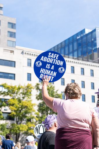 Protesters holding up pro-abortion rights signs at the 2021 Women's March.