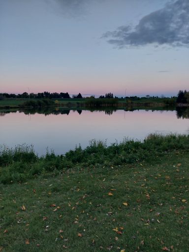 The sunset sky over the pond in the evening