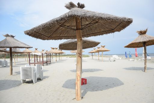 A beautiful view of umbrellas made of straws on the beach in Romania