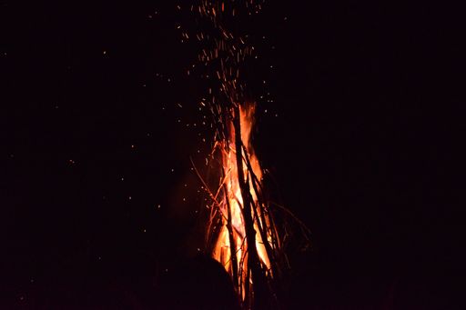 A closeup shot of a big burning bonfire at night