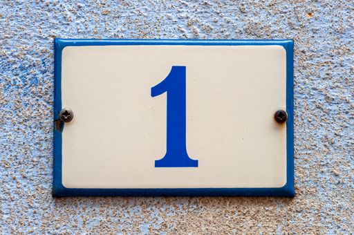 A closeup shot of number one on the wall