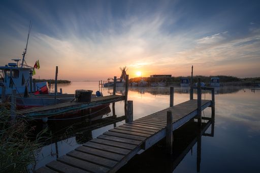 A serene view of a golden sunset in Lyngvig Fyr at the North Sea in Denmark