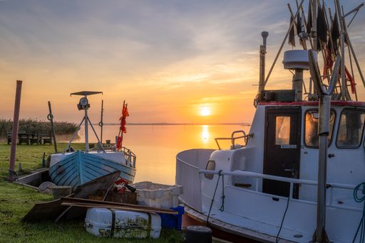 A serene view of a golden sunset in Lyngvig Fyr at the North Sea in Denmark