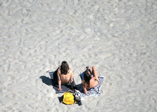 An overhead view of the two people relaxing on the beach
