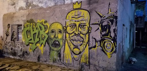 A creative colorful street art graffiti on a grungy weathered old concrete wall in Cienfuegos city