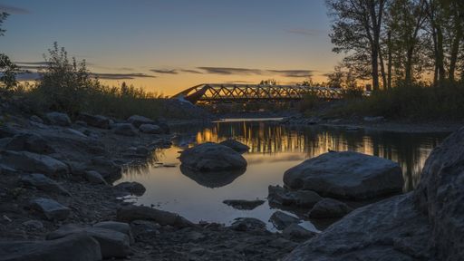A beautiful view of the Peace Bridge over the river captured in Calgary, Canada