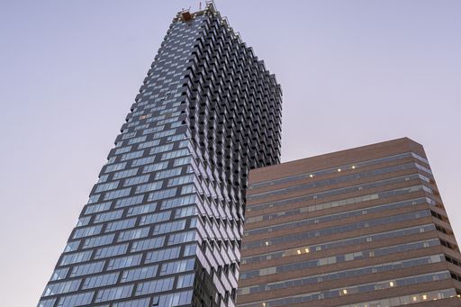 A low angle shot of Telus Sky tower captured under the blue sky in Calgary, Alberta, Canada