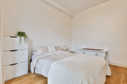 A beautiful image of a decorated double bedroom in a white interior design house; design ideas