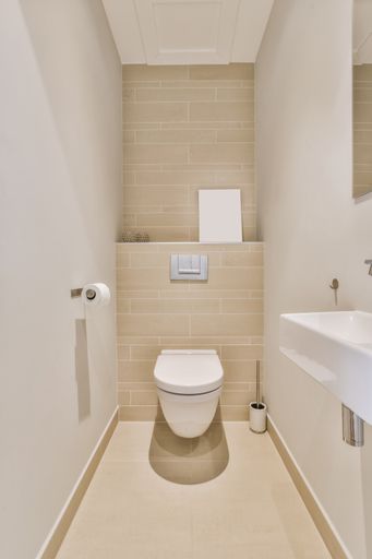 A beautiful vertical image of a modern bathroom in a white interior design house; design ideas