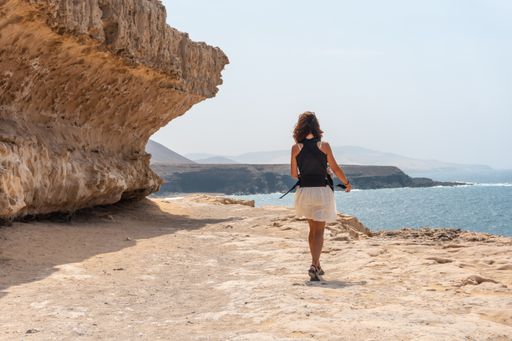 A young woman walking near the Cuevas de Ajuy, Pajara, west coast of the island Fuerteventura, Canary Islands, Spain
