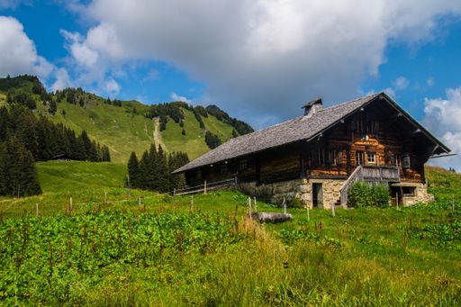 A beautiful view of a cute house under the blue cloudy sky