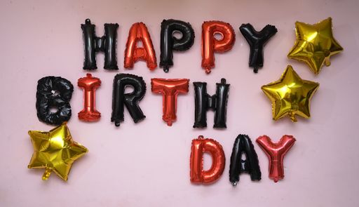 The pink wall with a happy birthday message made from balloons.