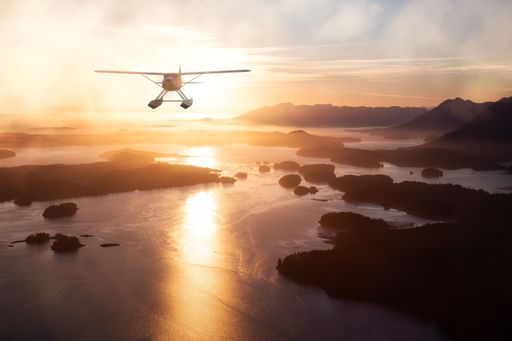 Seaplane flying over the West Coast of Pacific Ocean. 3d Rendering Airplane. Aerial Background from Tofino, Vancouver Island, British Columbia, Canada