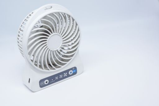 A white USB and battery-operated rechargeable fan isolated on a white background
