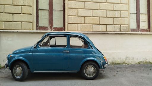 view of an old  classic fiat five hundred car parked on the street