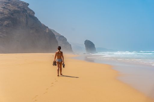 A woman on the Roque Del Moro in Cofete beach, Jandia natural park, Barlovento, south of Fuerteventura, Canary Island, Spain