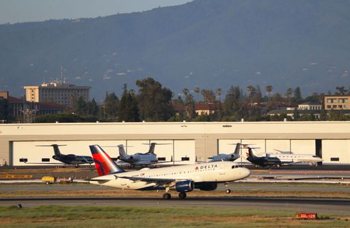 Delta Airlines Airbus A319 taking off at San Jose airport with mountains in the background