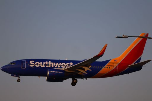 Southwest Airlines Boeing 737-700 lands at San Jose airport during sunset, arriving from Santa Ana