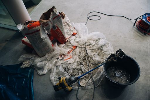 A top view of construction materials placed on a white cloth on the ground