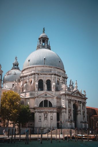 A gorgeous vertical shot of the Santa Maria della Salute church in Venice, Italy under a light blue sky