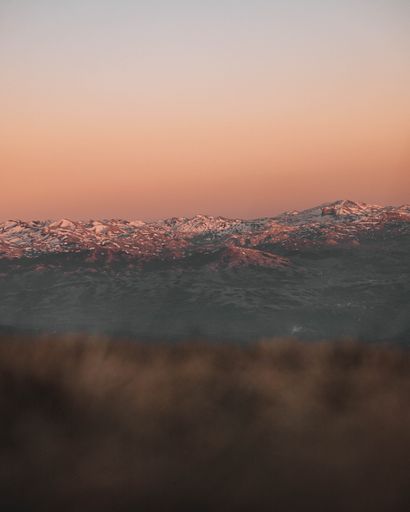 A landscape view of the mountainous area under the sunset sky in autumn