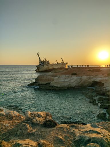 A vertical shot of the Edro III Shipwreck surrounded by the sea in Peyia, Cyprus