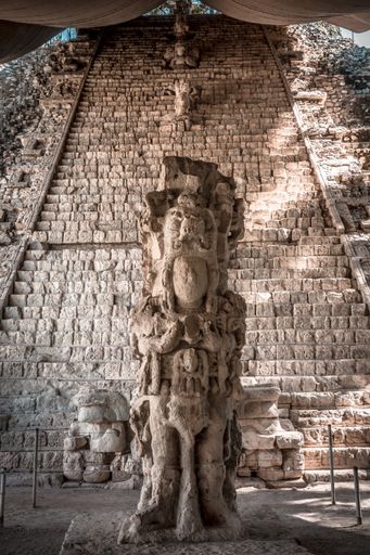 Several statues on the stairs of the Mayan Ruins in Honduras