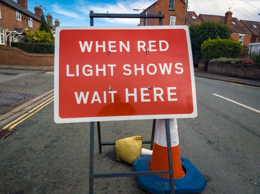 A red warning sign at road works