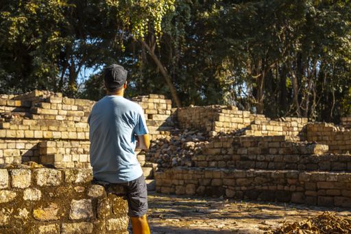A behind shot of the young man visiting Copan Ruinas and its beautiful Mayan ruins in Honduras