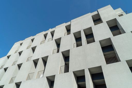 A Low angle shot of a high rise modern building against a clear blue sky in Porto, Portugal