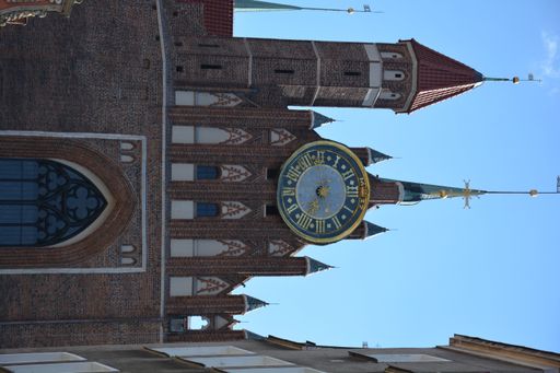 A vertical shot of the historic gothic catholic St. Mary's Church in Gdansk against a blue sky