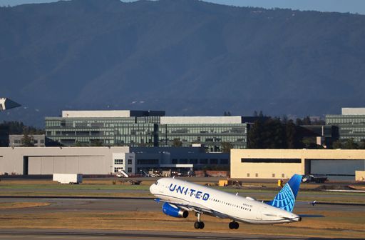 United Airlines Airbus A320 taking off with mountains in the background