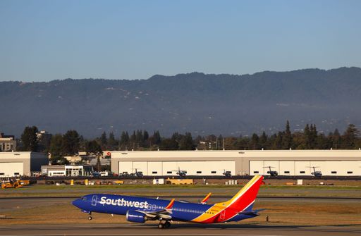 Southwest Airlines Boeing 737 MAX 8 taking off at San Jose airport with Santa Cruz mountains behind