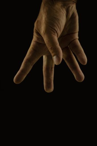 A man's hand on isolated black background